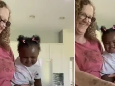 Baby laughs heartily while grandmother chops vegetables