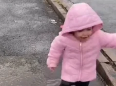 In a trending video, a little girl loves playing in a puddle